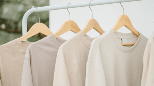 sweaters of skin color hanging in hangers